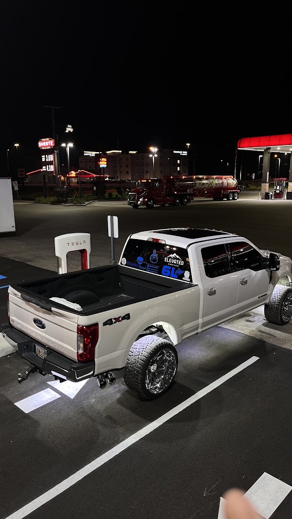 Lifted white Ford F-250 Super Duty with mirror-finish chrome wheels detailed by Elevare Lux Detailing